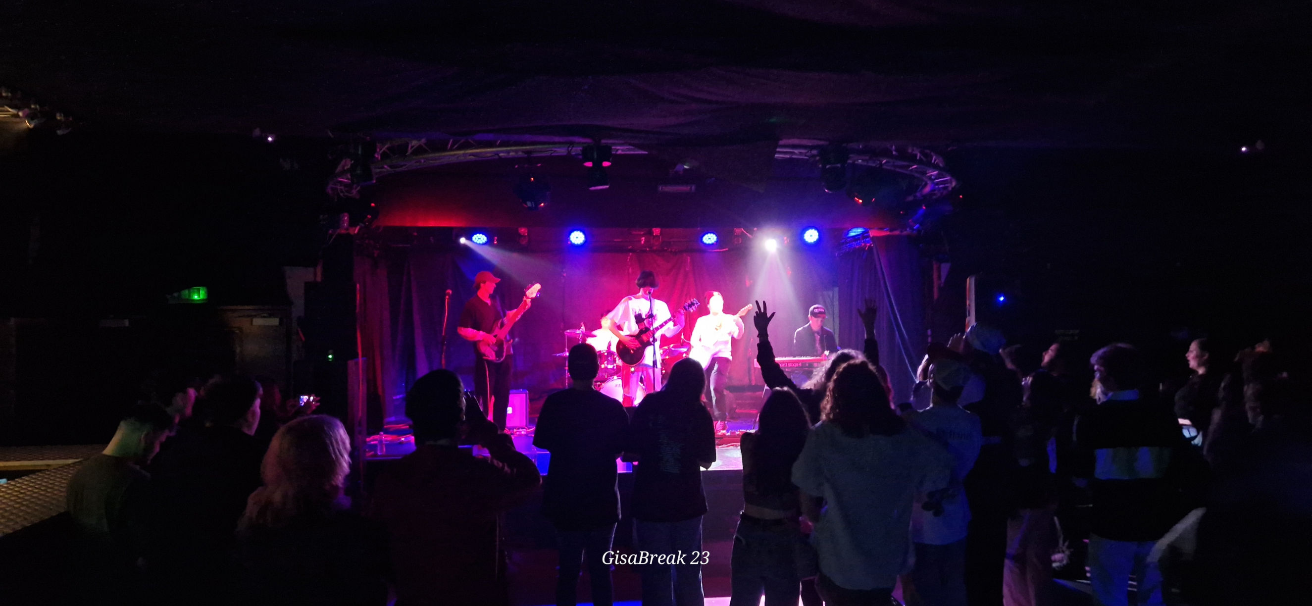 music students performing on the stage of a busy nightclub