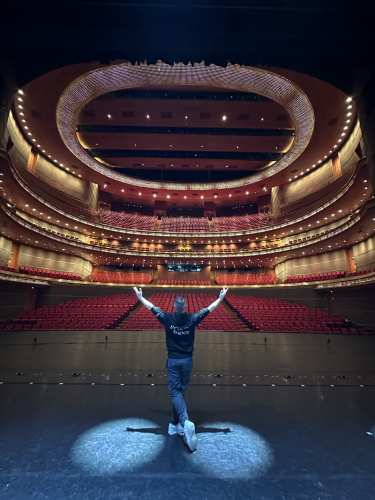 Joe, Weston College's performing arts lecturer, in Beijing, China on stage in an empty theatre