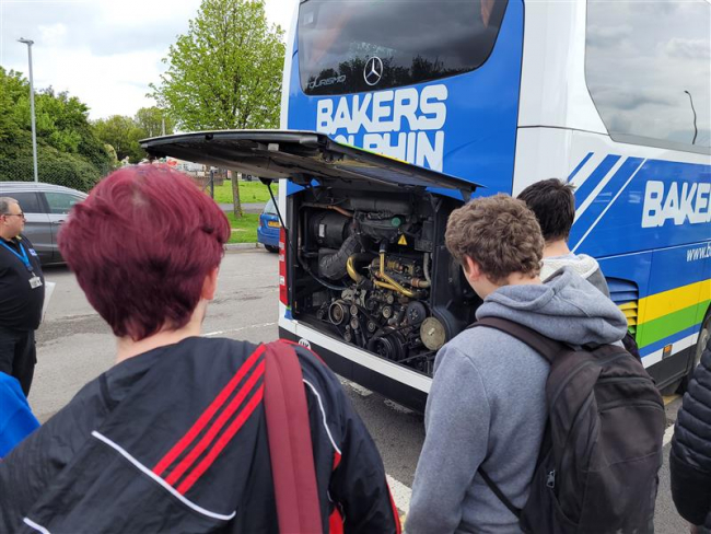 Bakers Dolphin showing students a coach engine