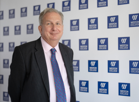 Sir Paul Phillips with Weston College Logo background