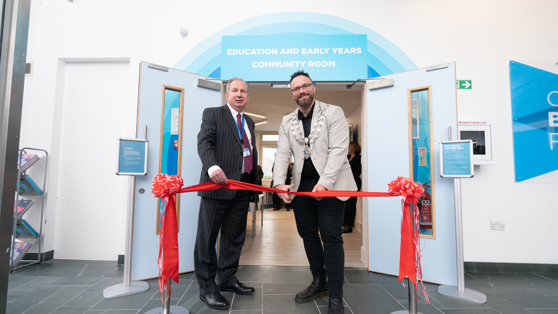 Dr paul cuts red ribbon to open new early years facilities