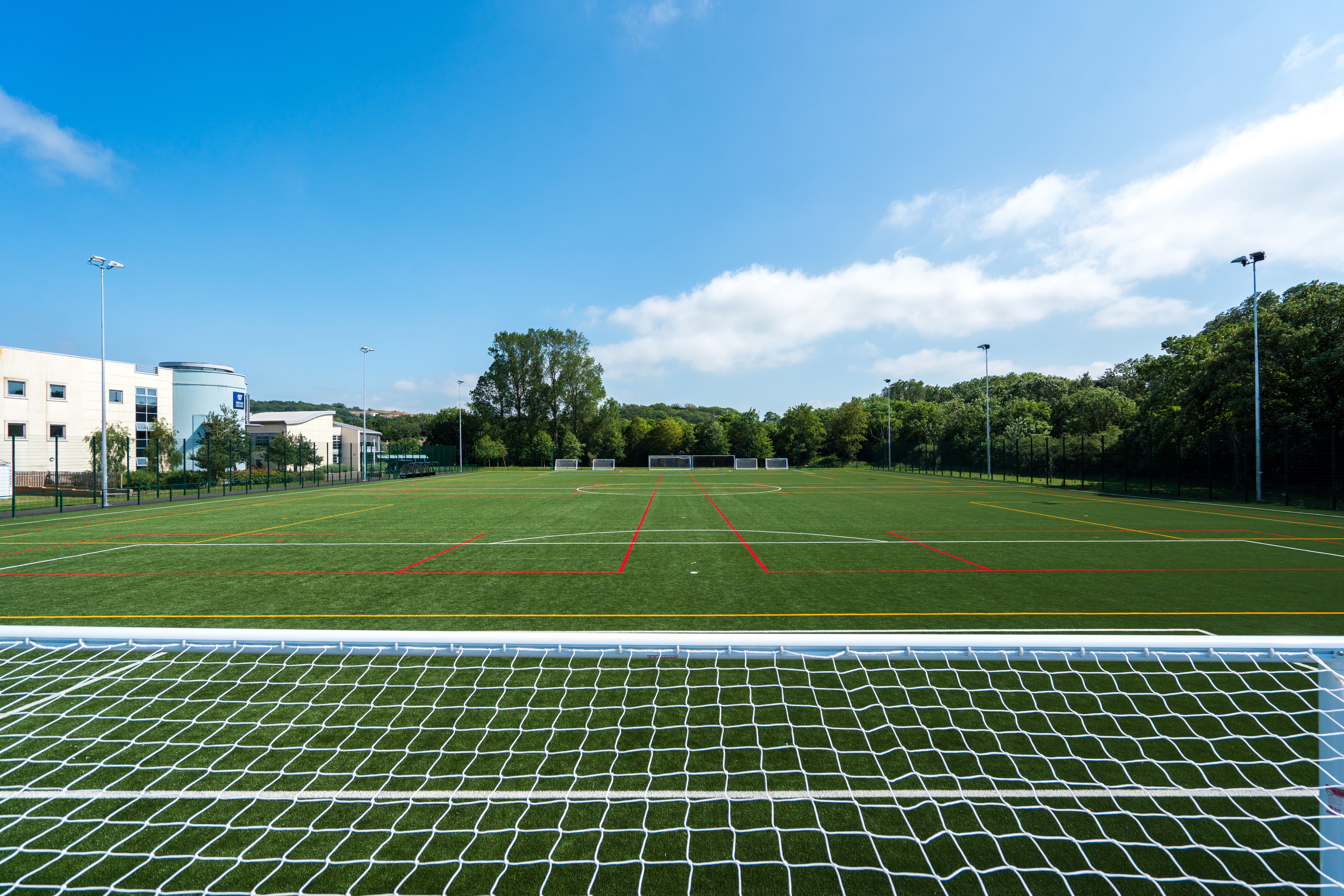 shot of 3g sports pitch from football goal perspective 