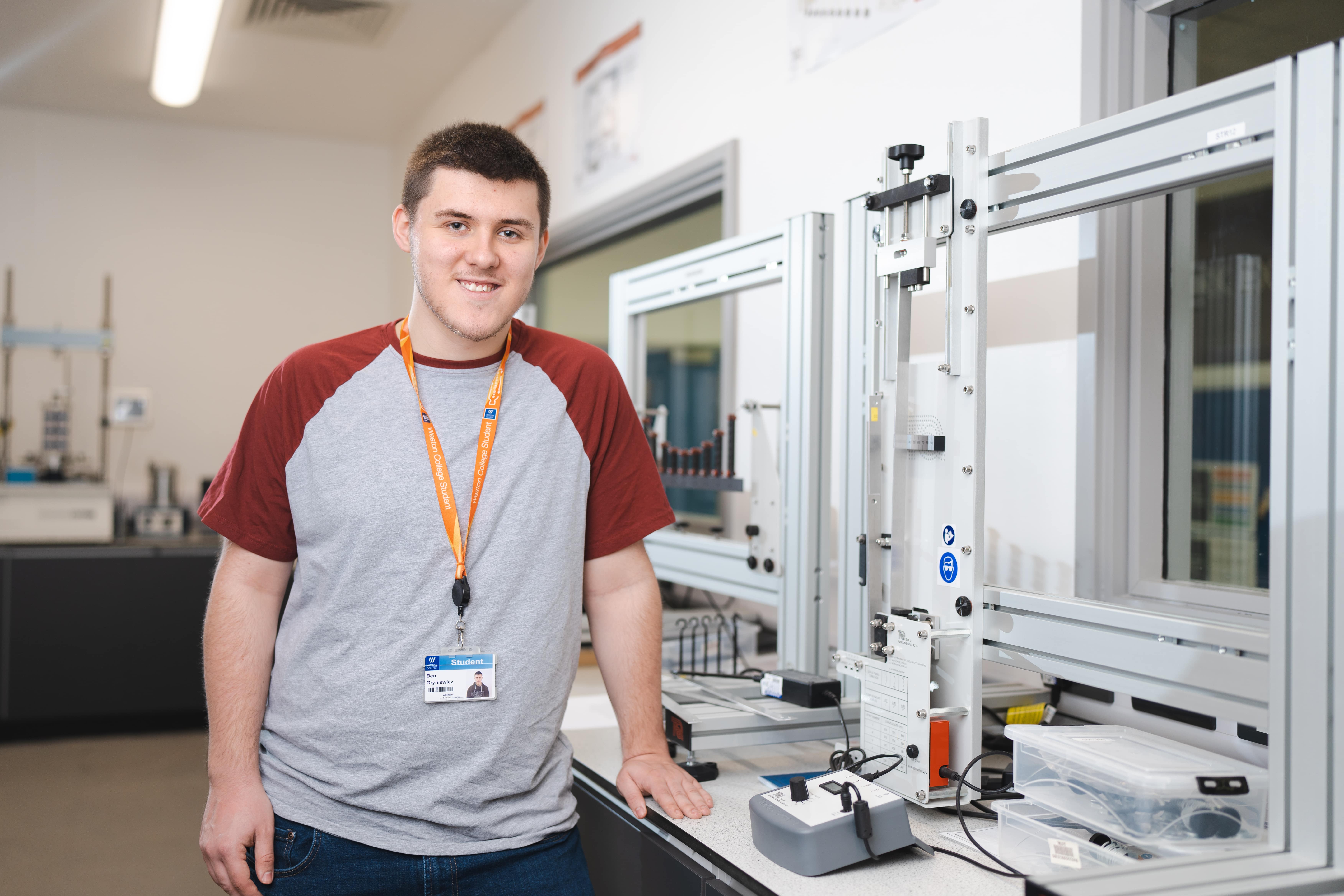 boy standing in room with a machine