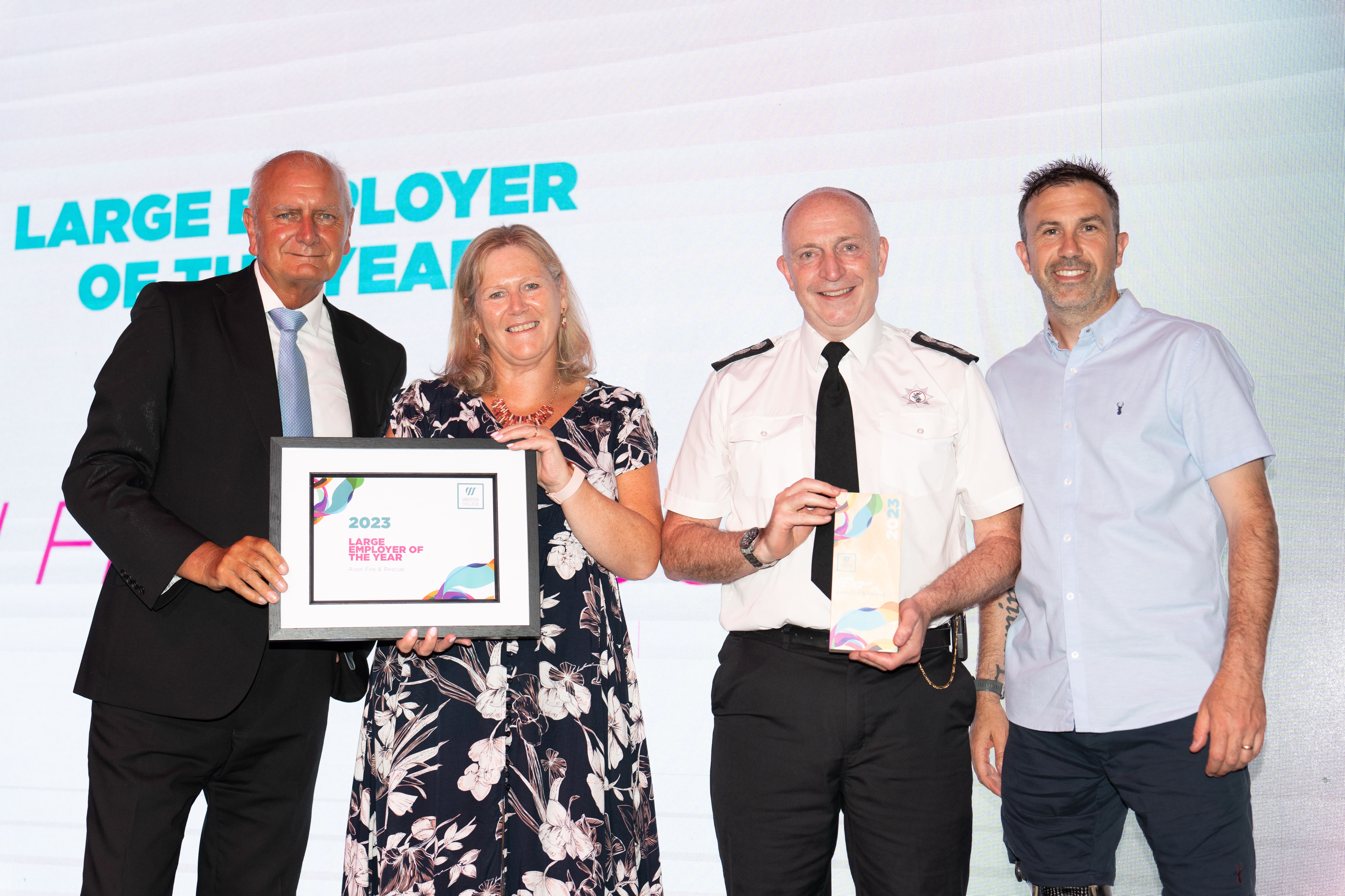 Avon Fire & Rescue, on stage holding thier award next to Andy Lewiss