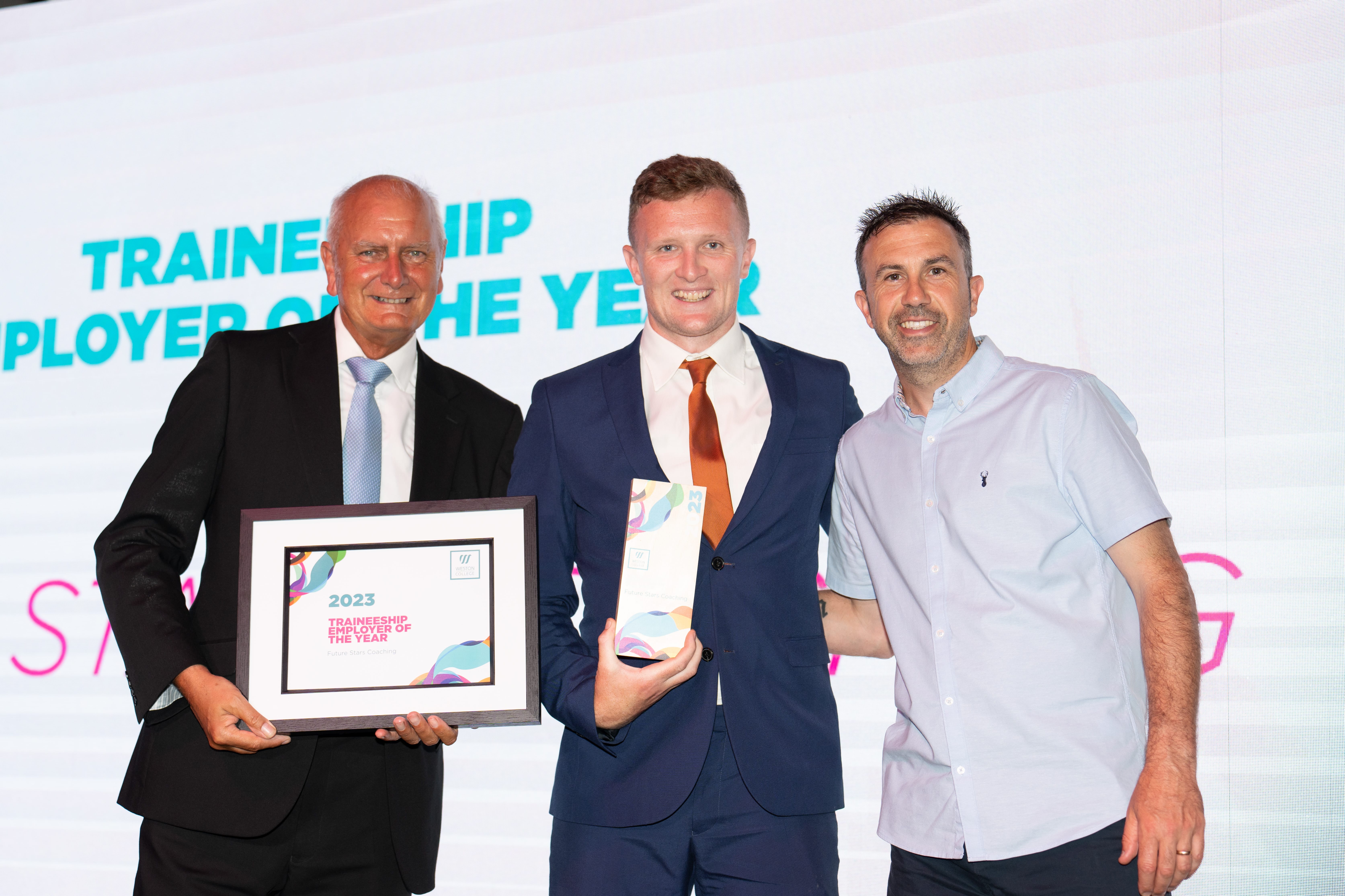 Future Starts Coaching, on stage holding thier award next to Andy Lewis