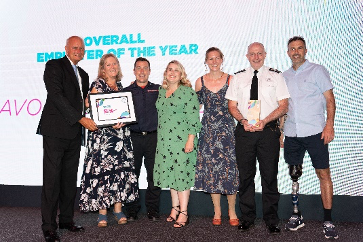 Avon Fire and Rescue, on stage holding thier award next to Andy Lewis