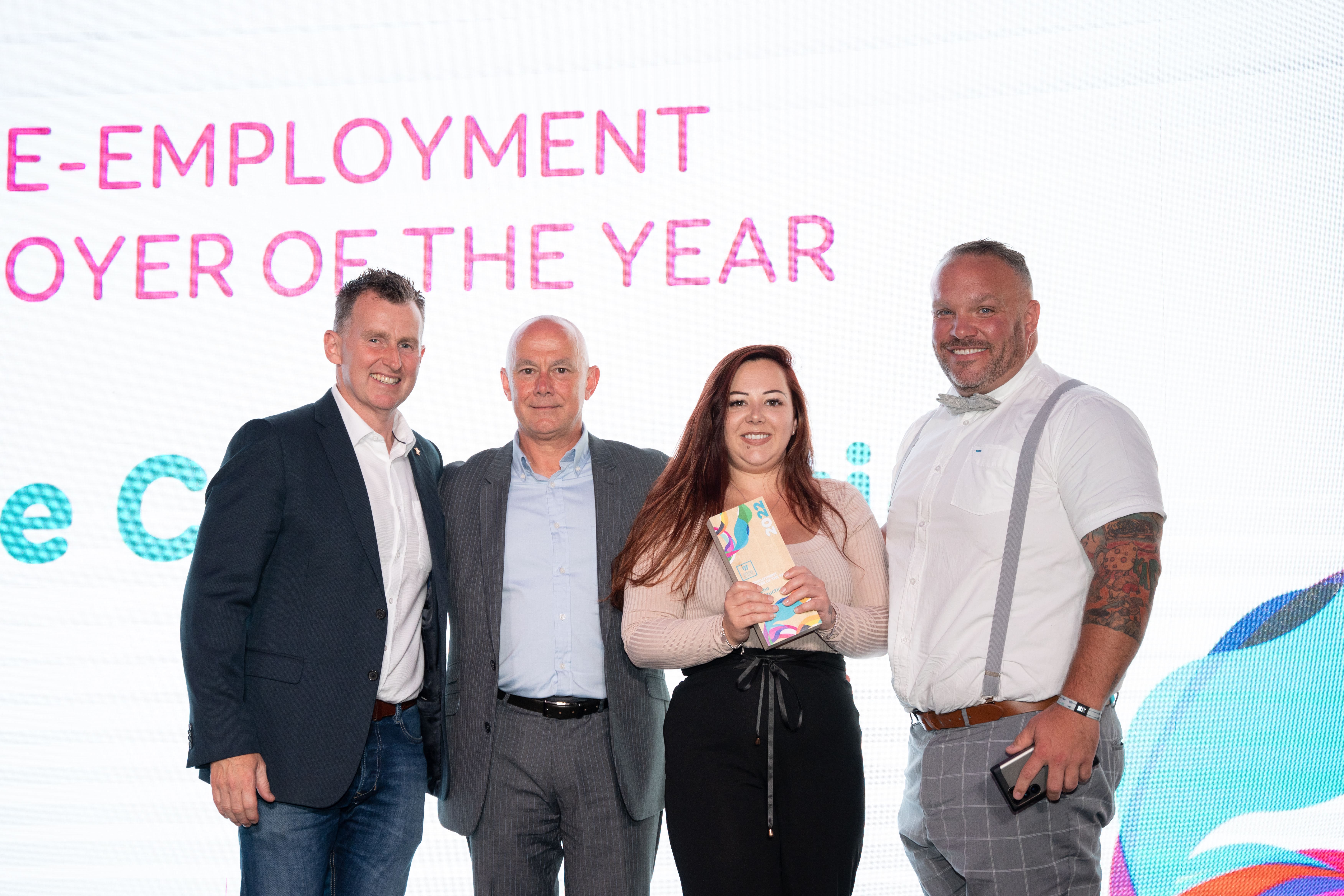 Apache Construction, on stage holding thier award next to Nigel Owens
