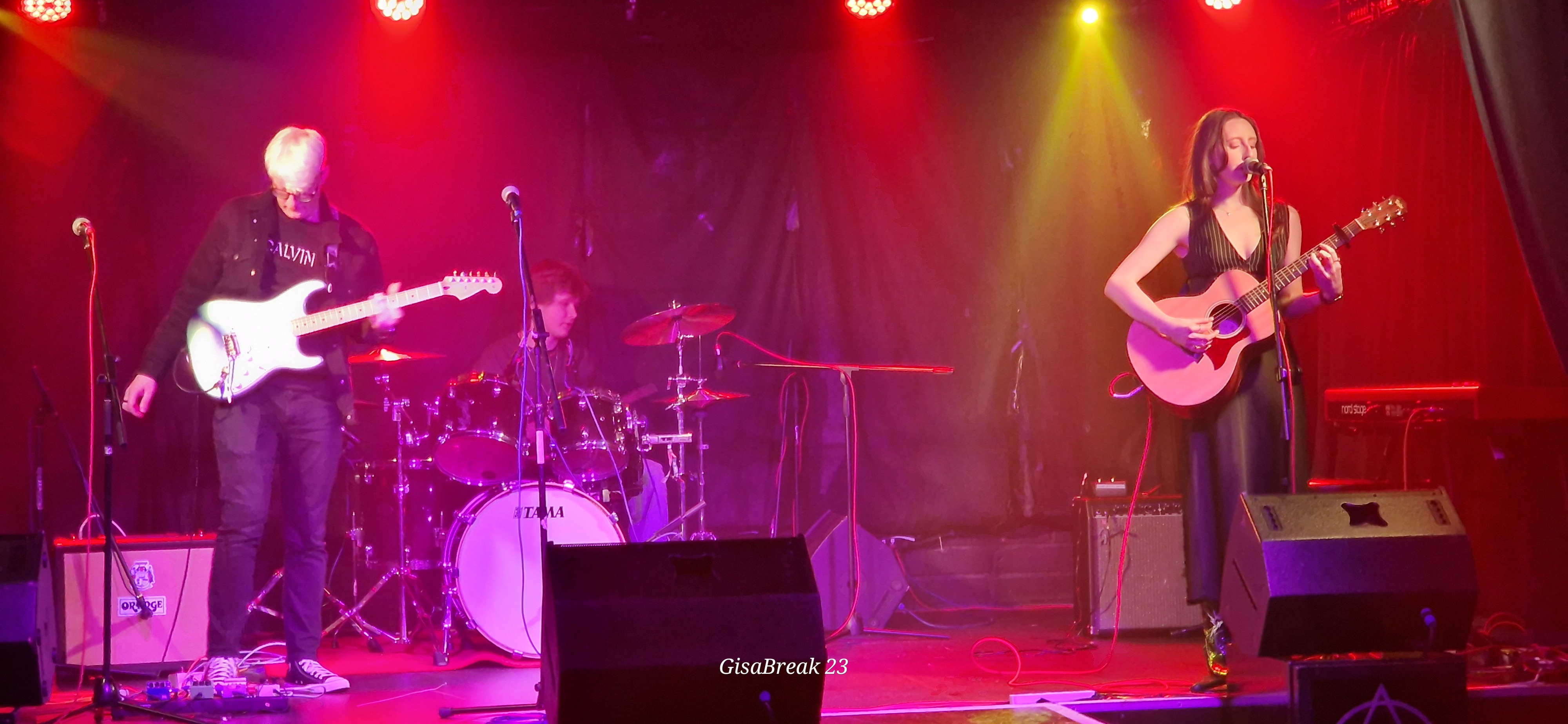 Our music students performing on the stage of a busy nightclub