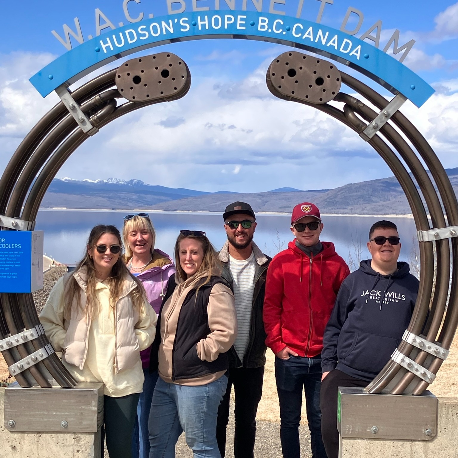Students standing in front of the Bennett Dam sign