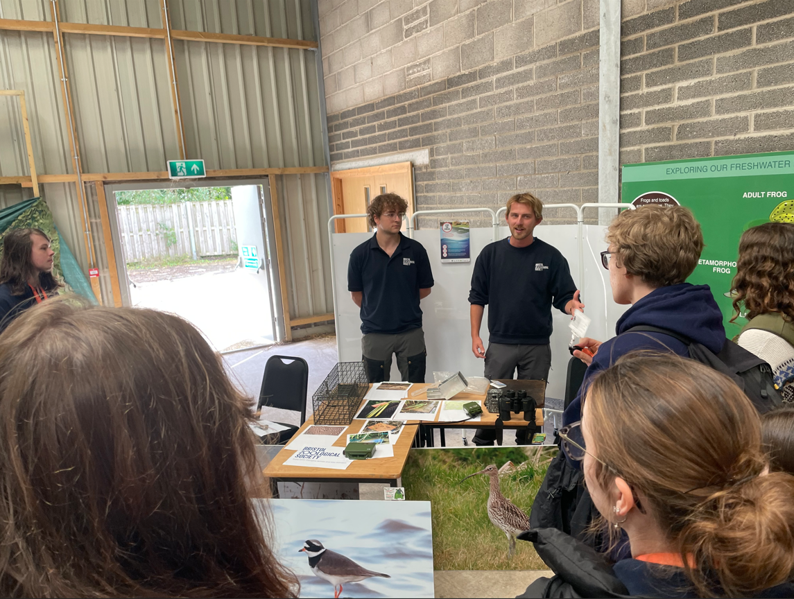 Students standing listening to the talks