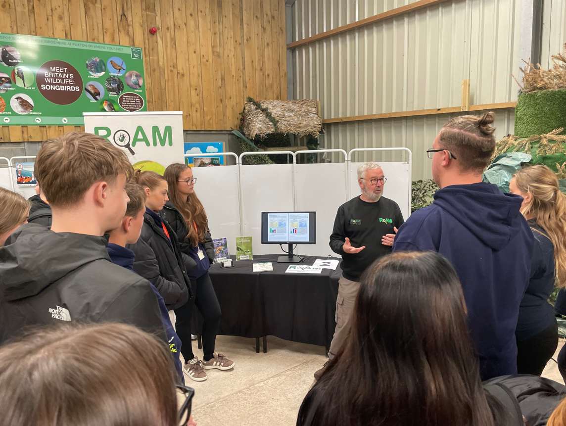 Students standing listening to the talks