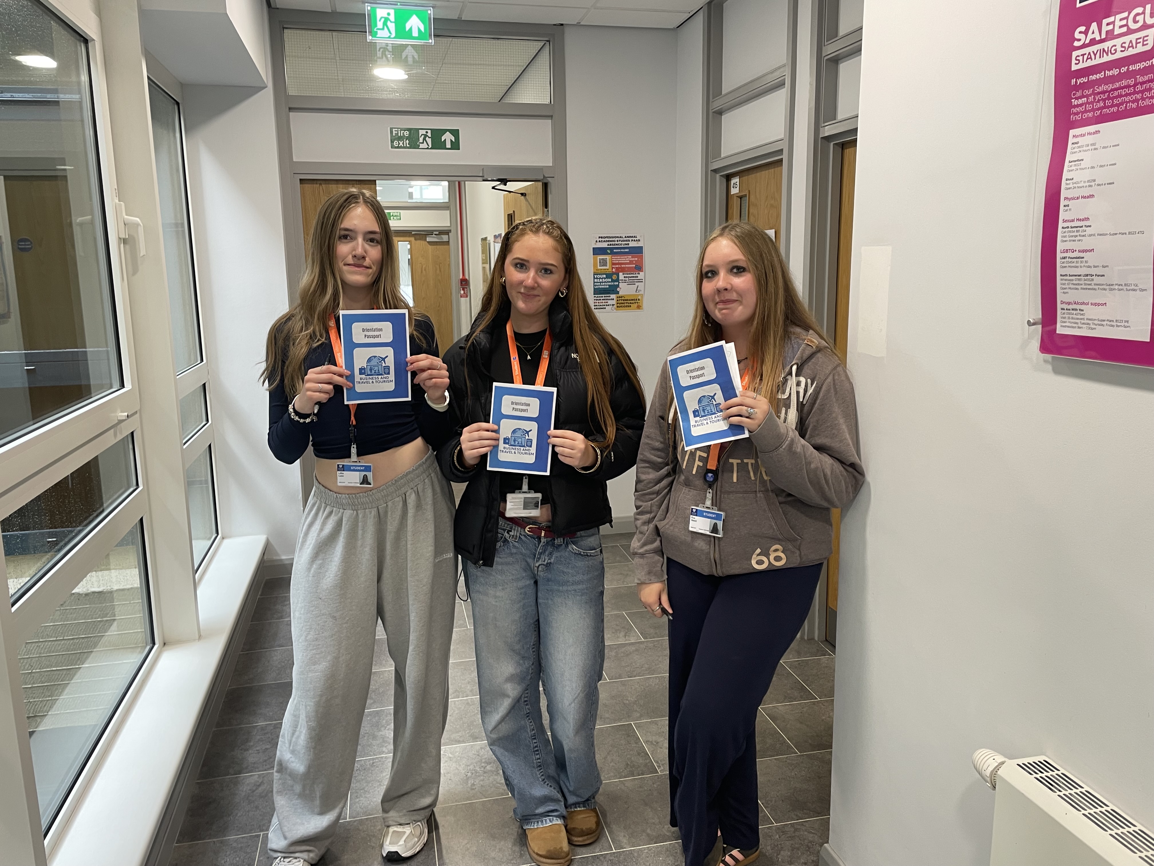 3 travel students holding passports they made