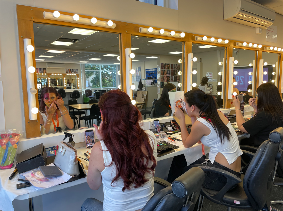 Media makeup students practicing creative face paint