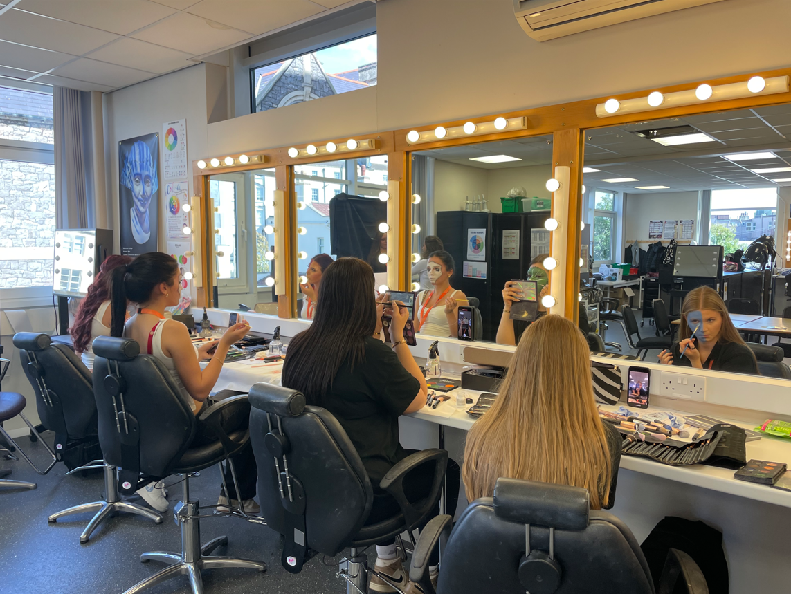 Media makeup students practicing creative face paint