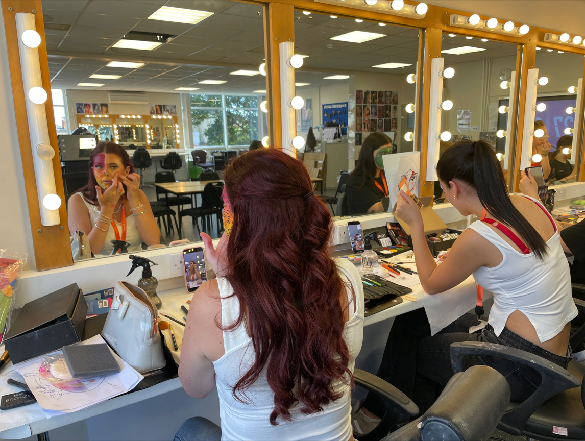 Media makeup students practicing creative face paint