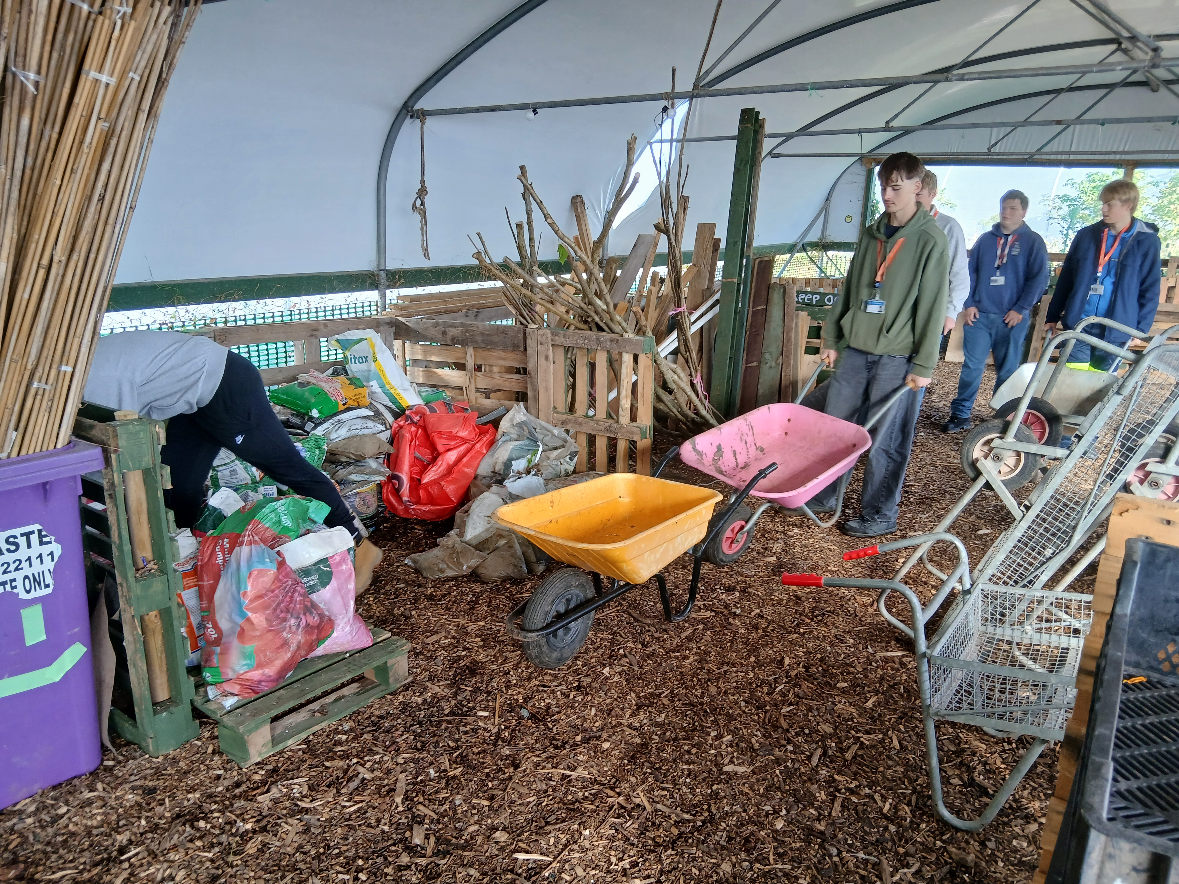 Student pushing a wheelbarrow