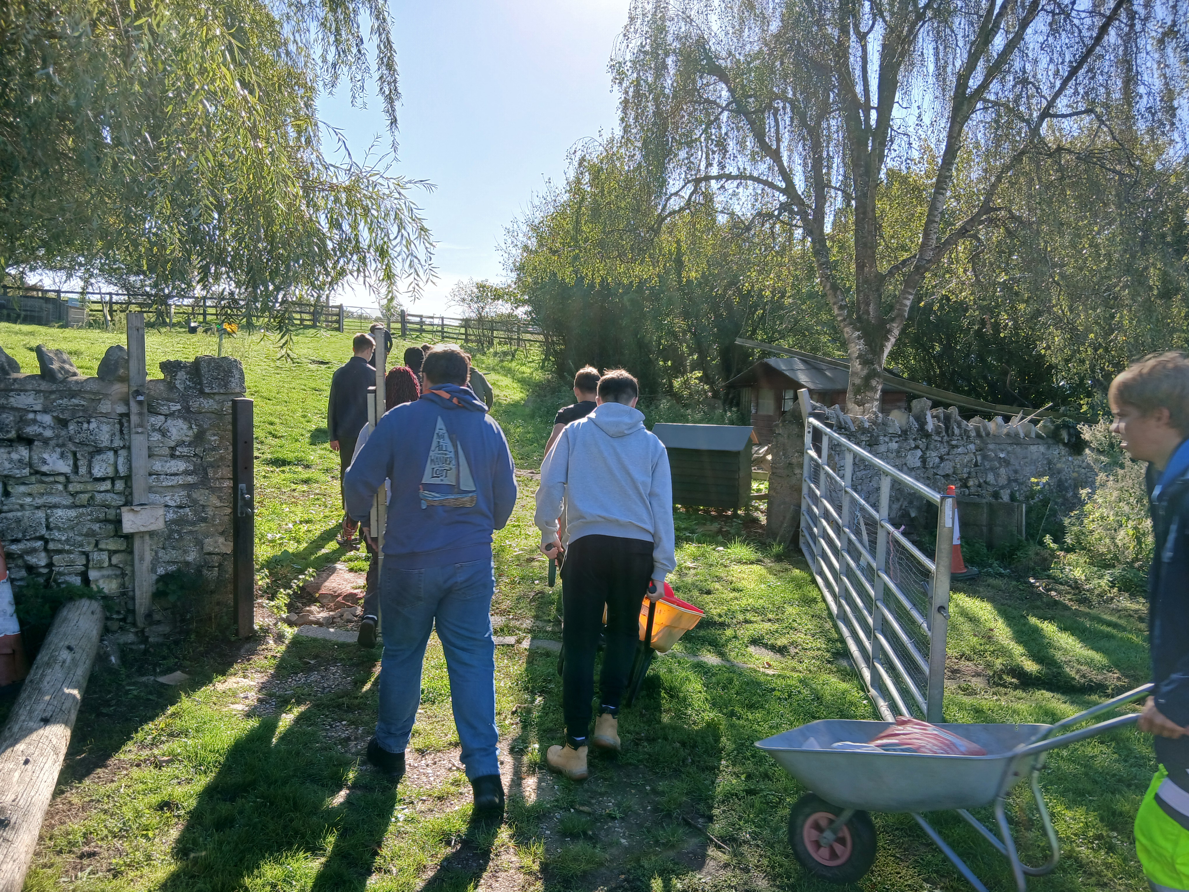 Students pushing wheelbarrows