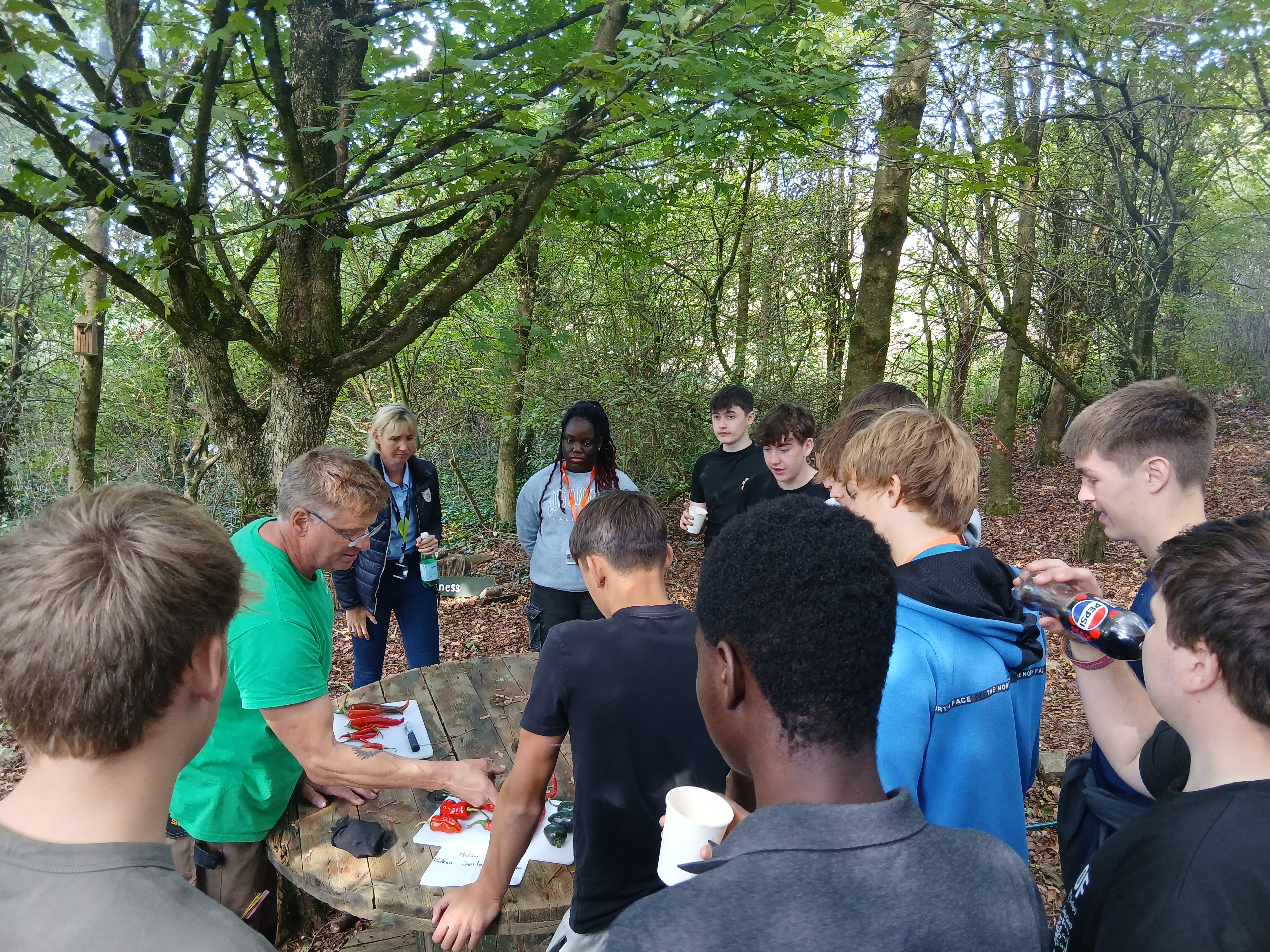 Students hearing about chilli's from a professional at the farm