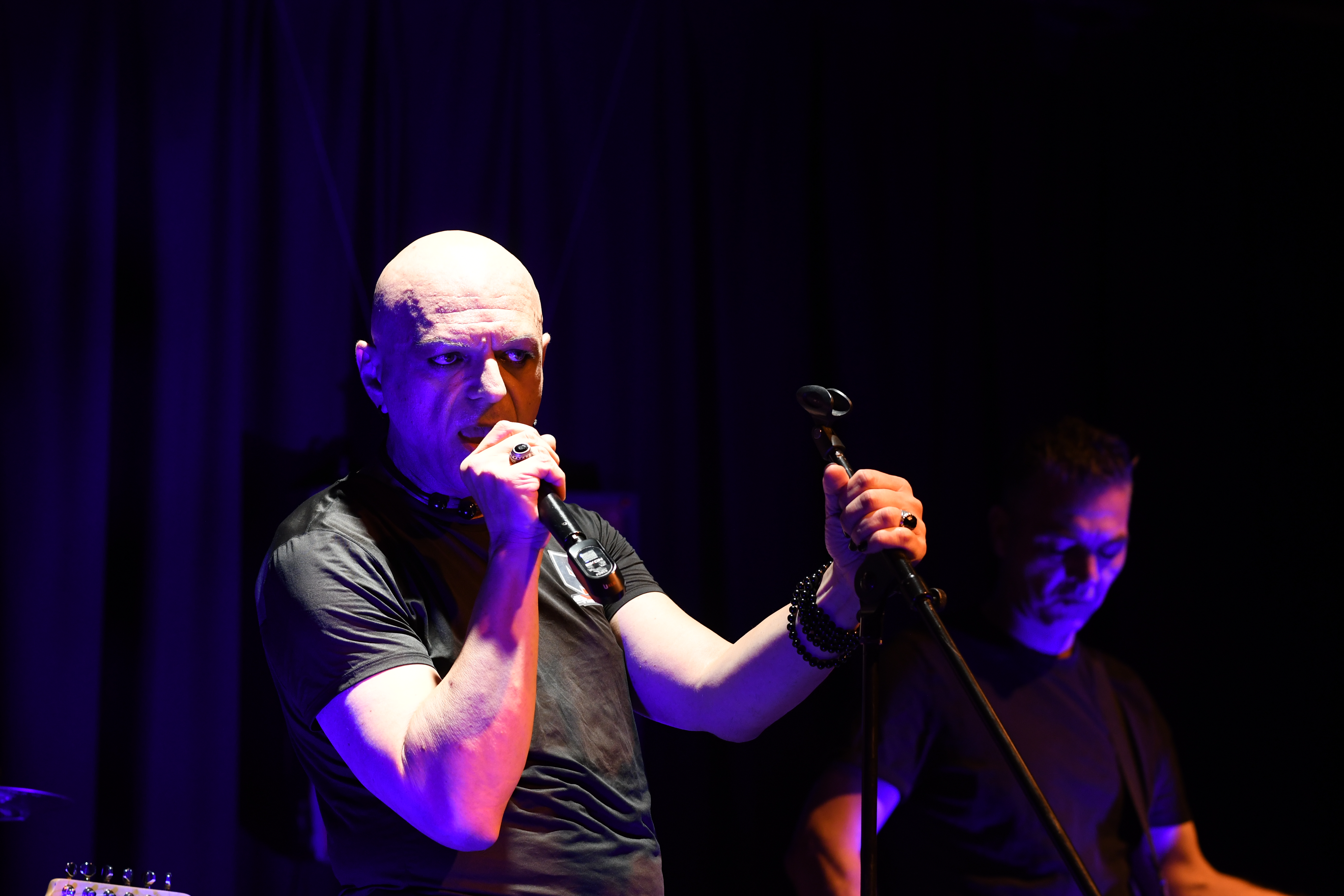 The Peripheries Lead Singer singing on stage