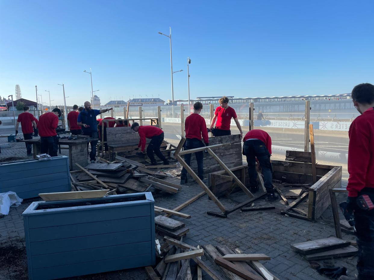 Students disassembling wooden benches