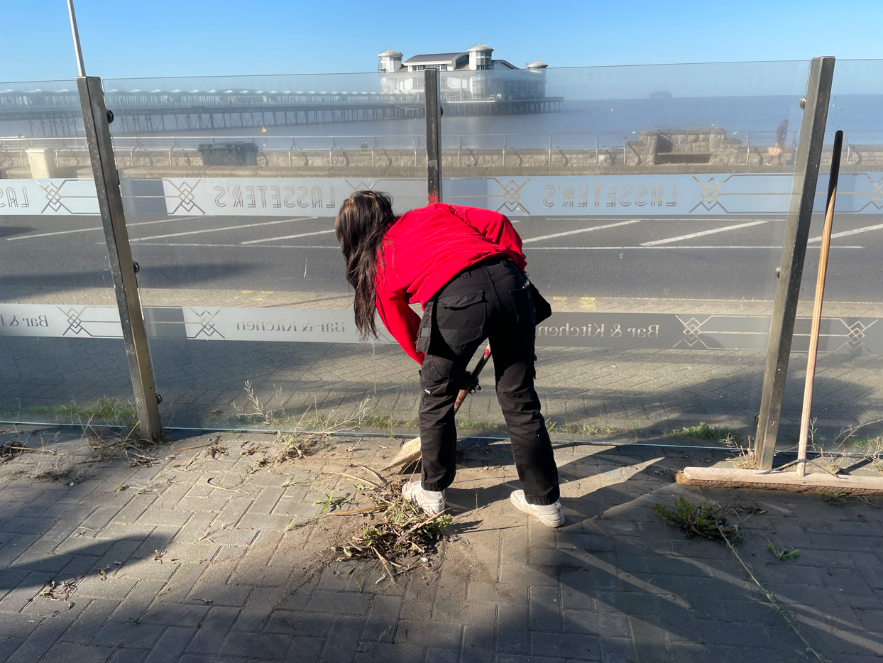 Student sweeping the floor