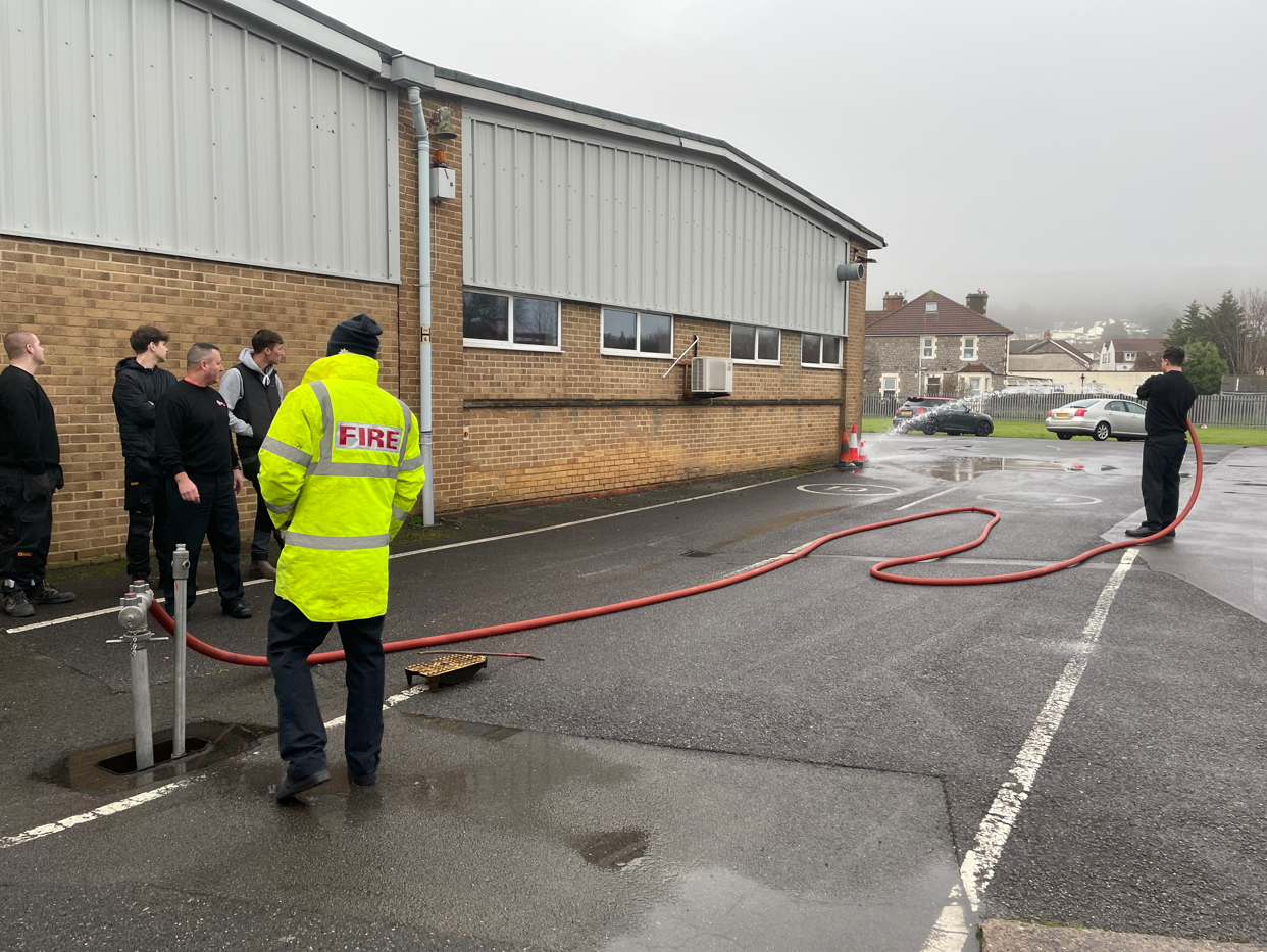 firefighter spraying water through the hose