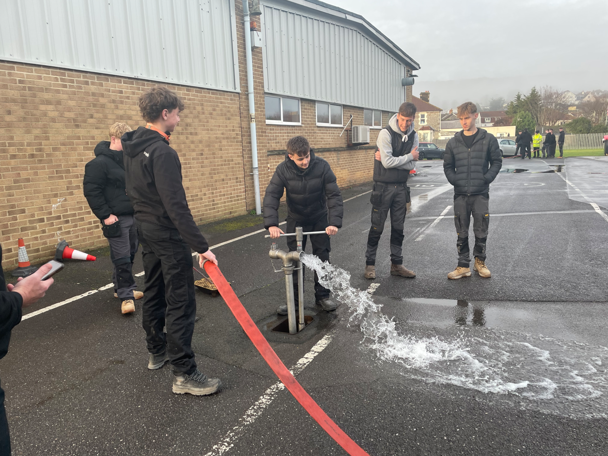 students tapping into fire hydrant water