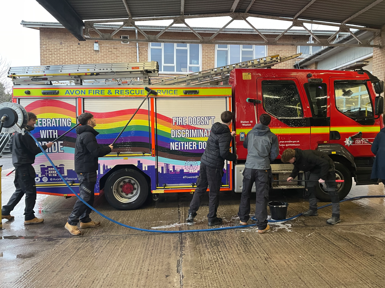 Students cleaning fire engine