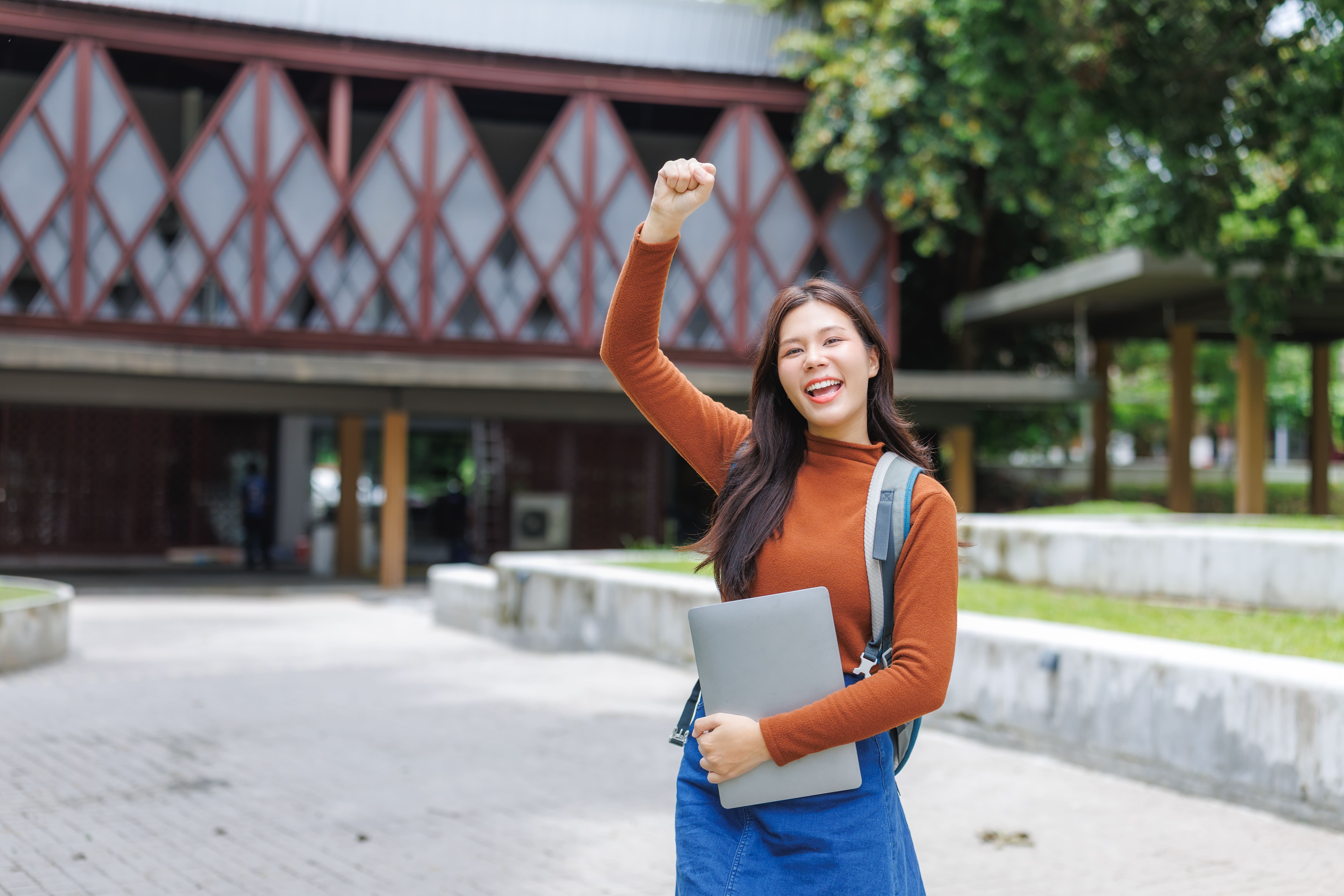 girl smiling holding a book