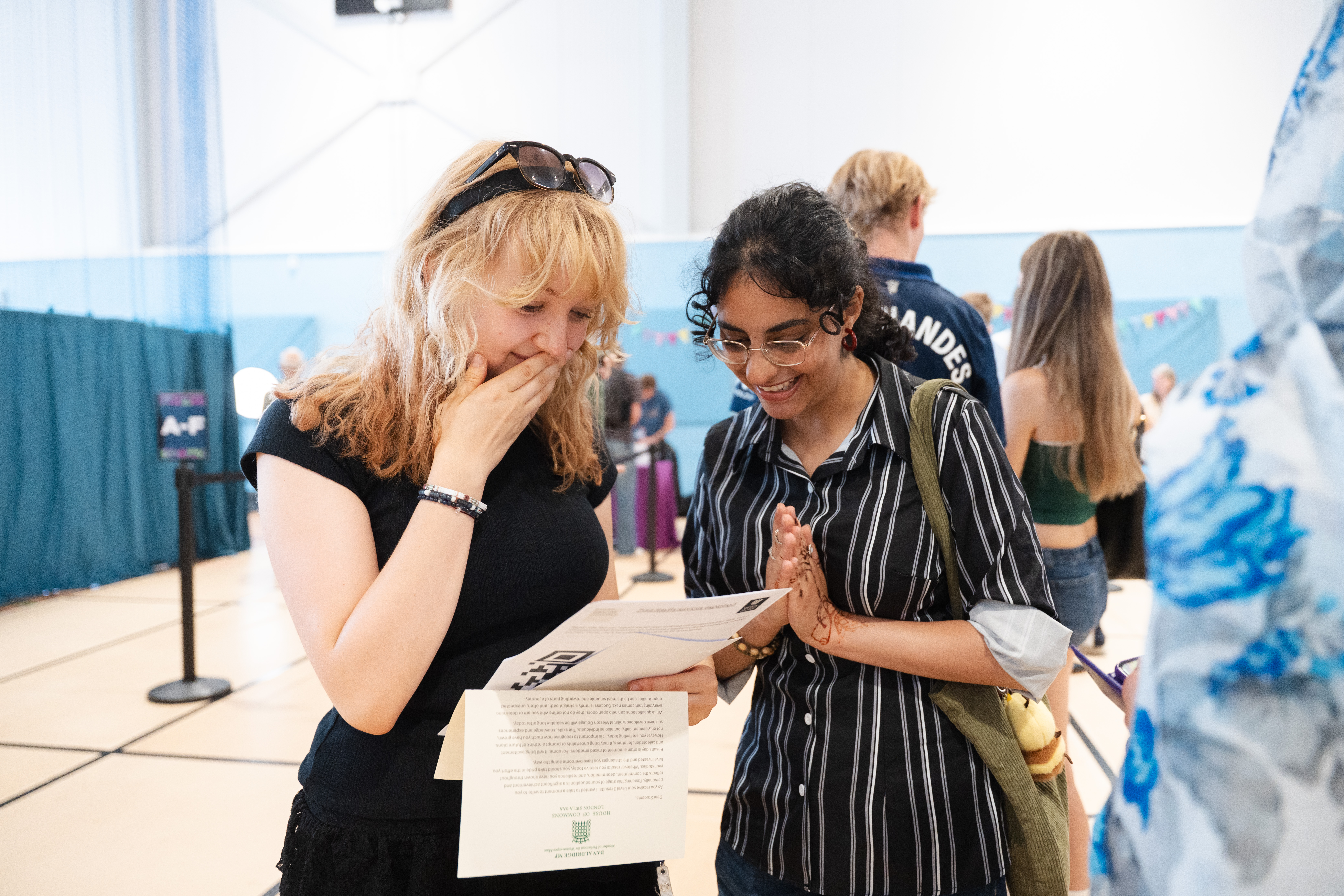 2 students looking at their results