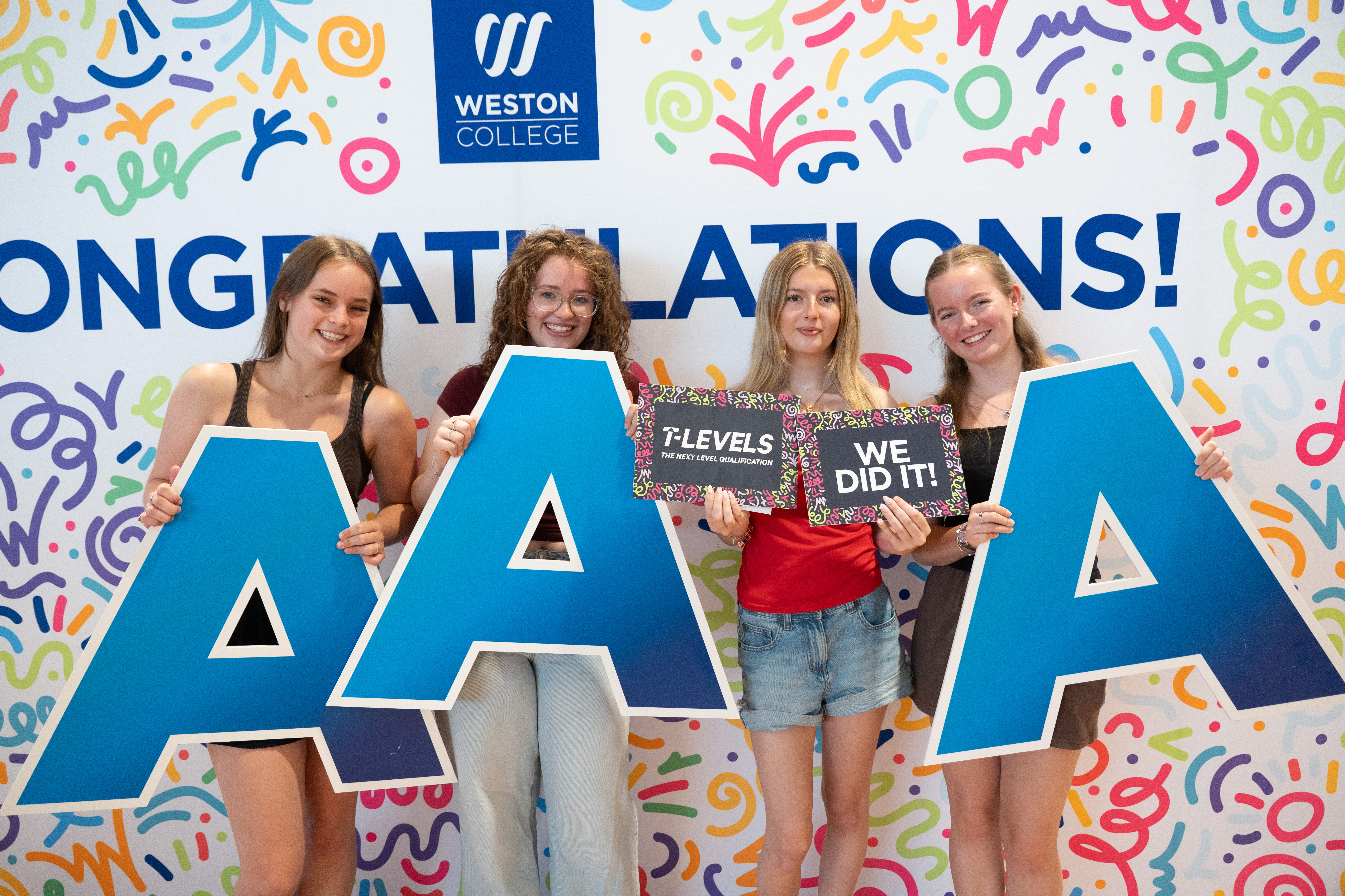 Students posing with photobooth props