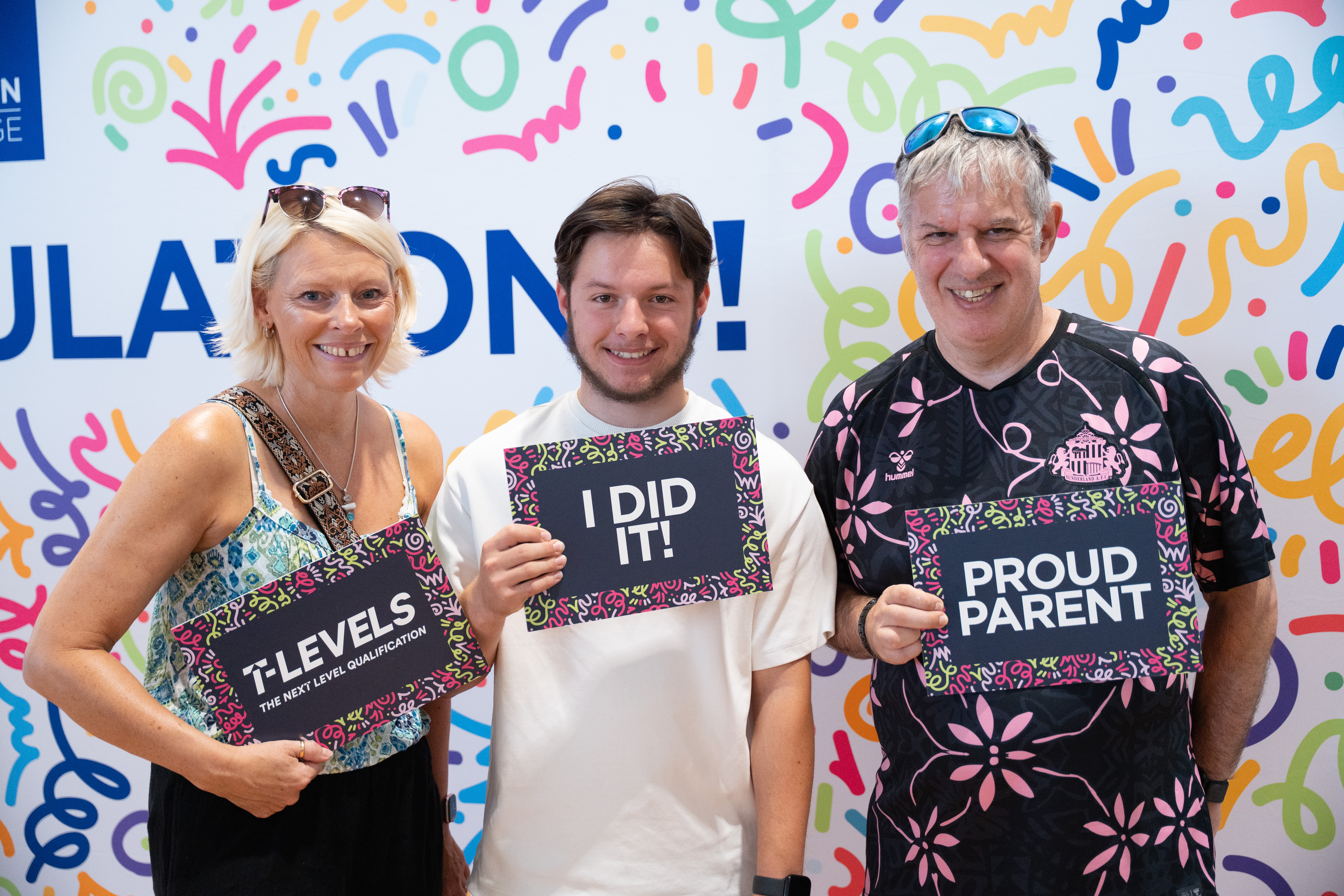 learner and parents with photo props