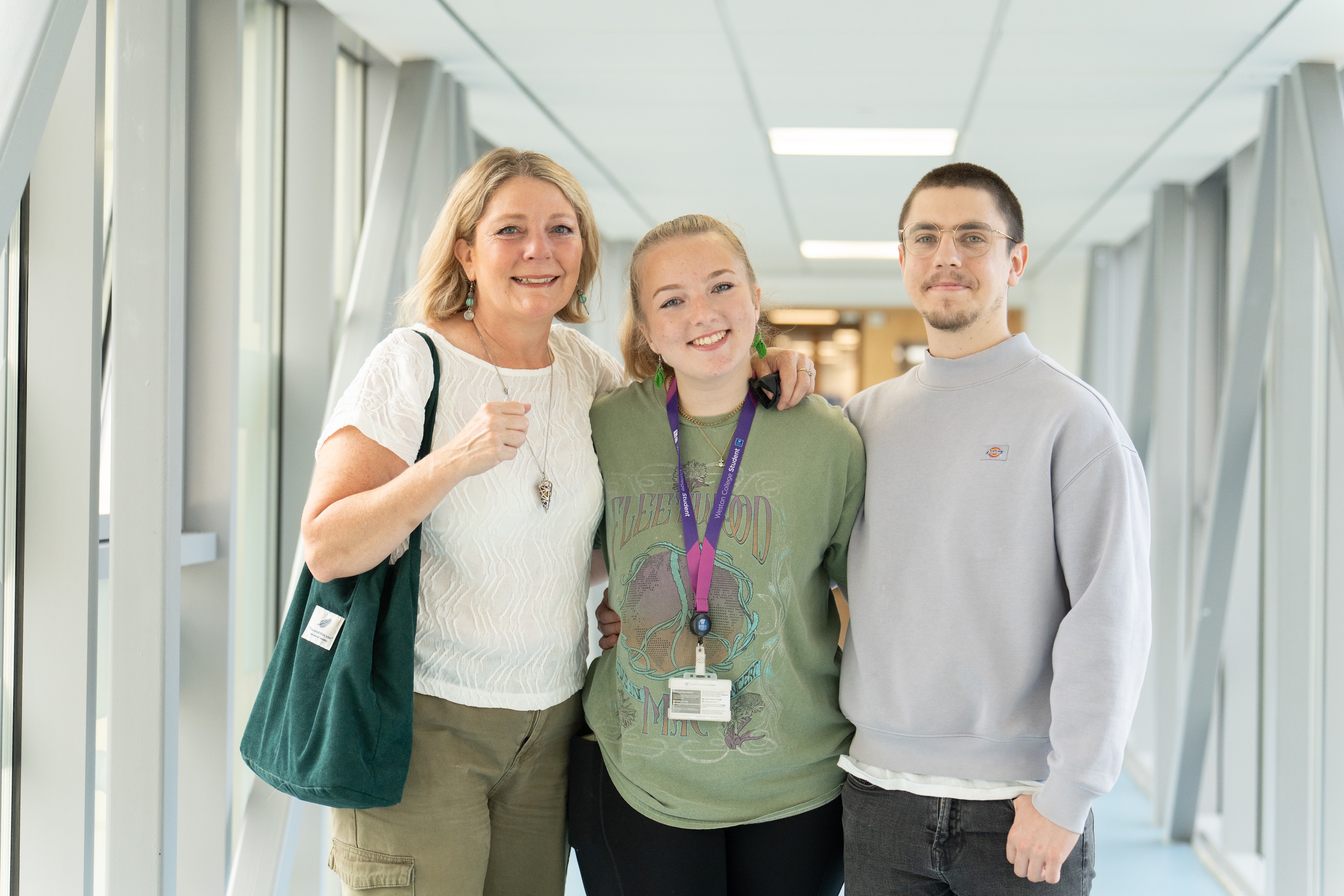 a student with her mum and brother smiling 