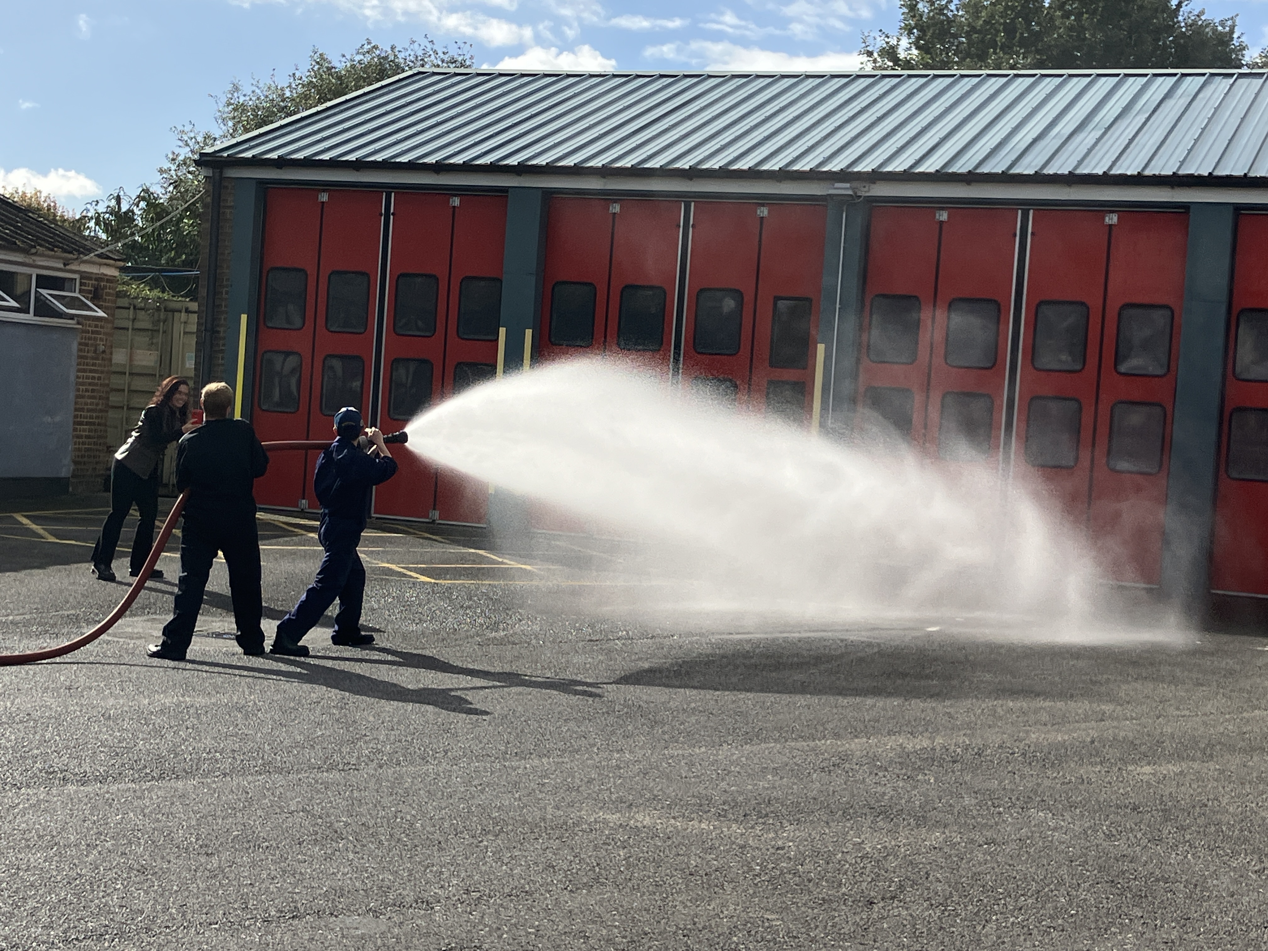 Students holding water hose