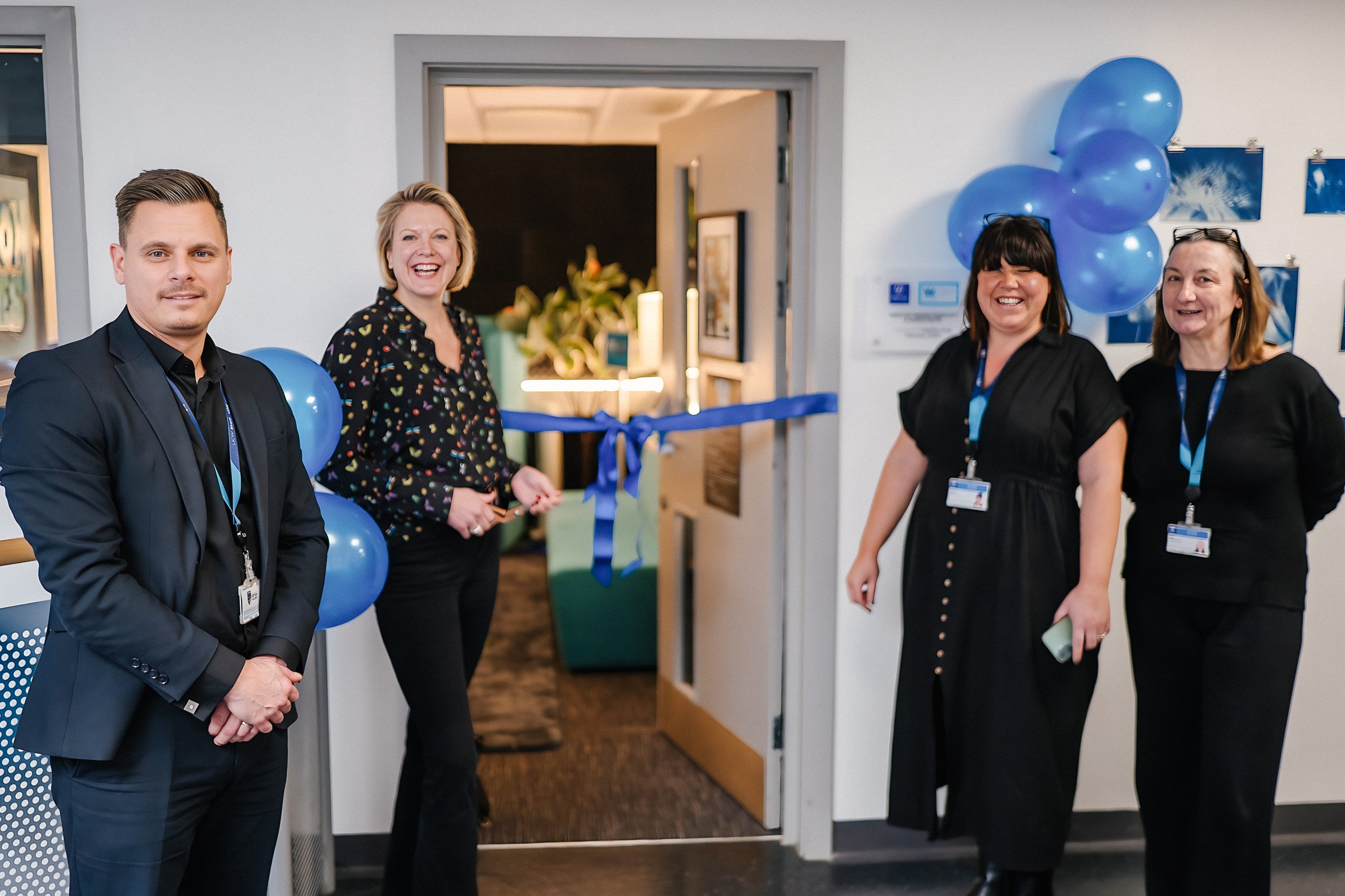 Sophie Long, Joe Abdulgani, Gina Hele and Mel Edmonds smile next to the new podcast suite
