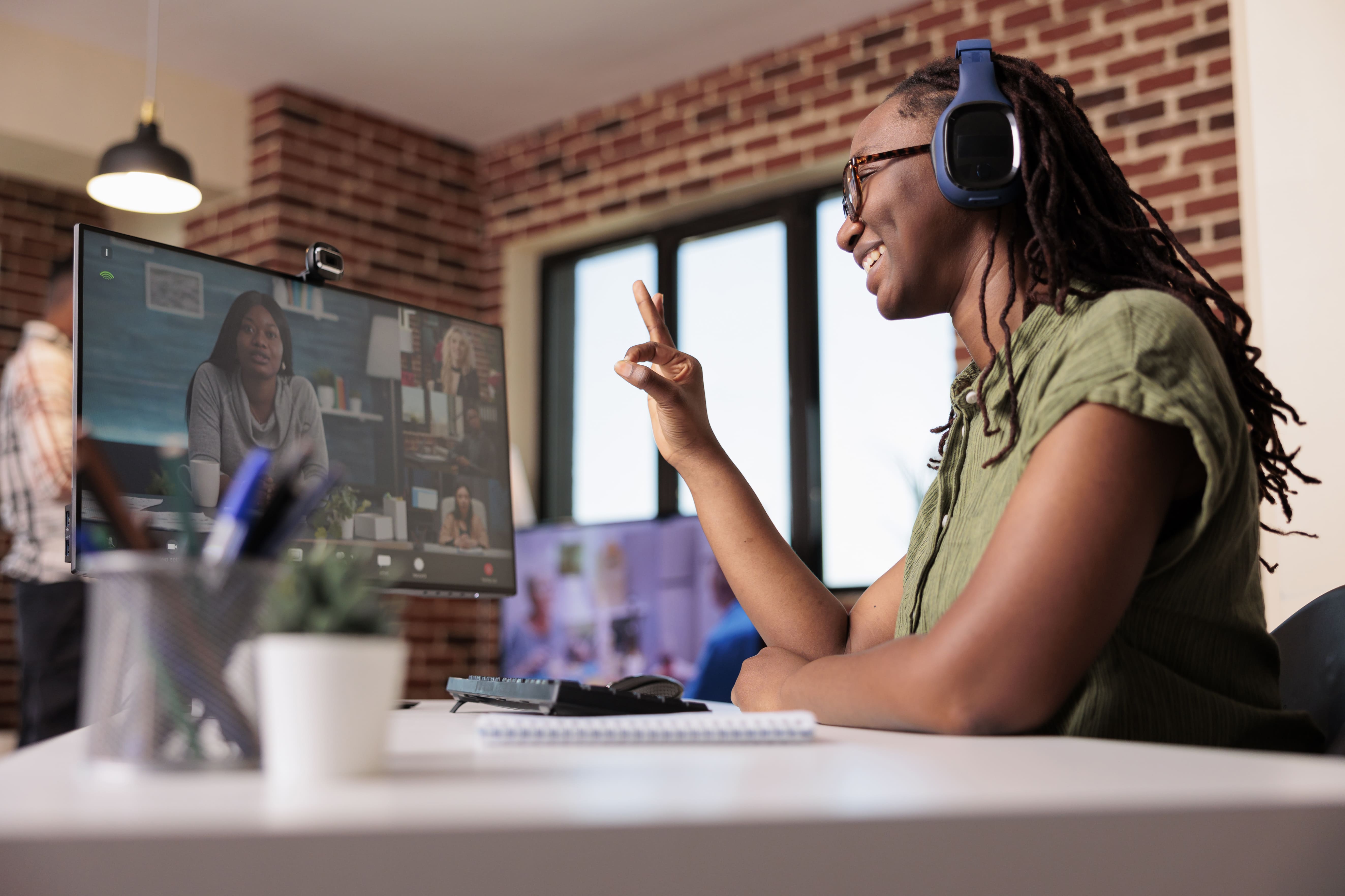 woman sitting at a desk on a zoom call