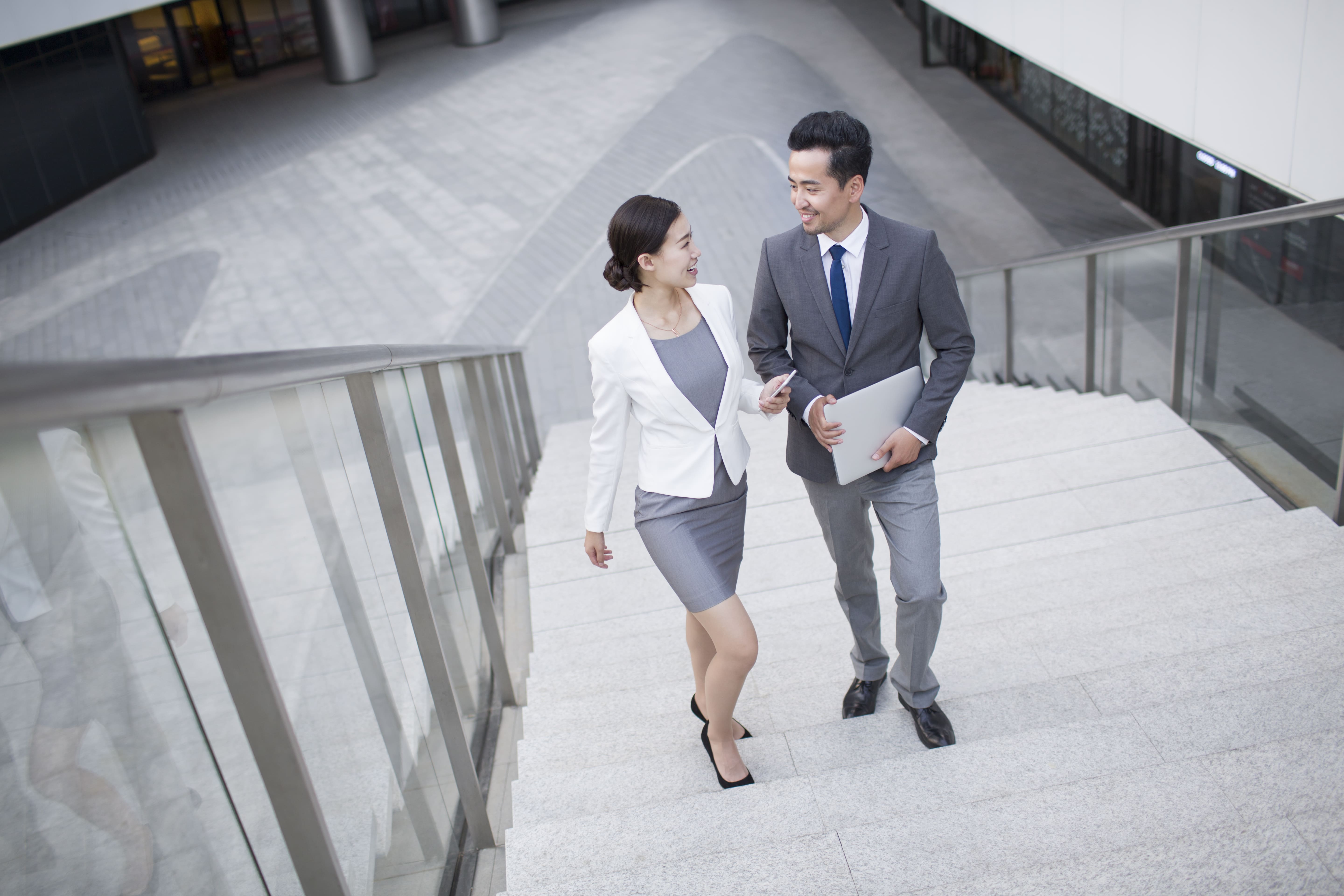 Business person talking on the stairs