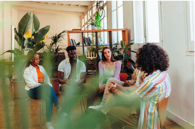 a group of people sitting around in a circle