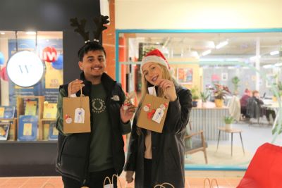Two learners holding their product and smiling
