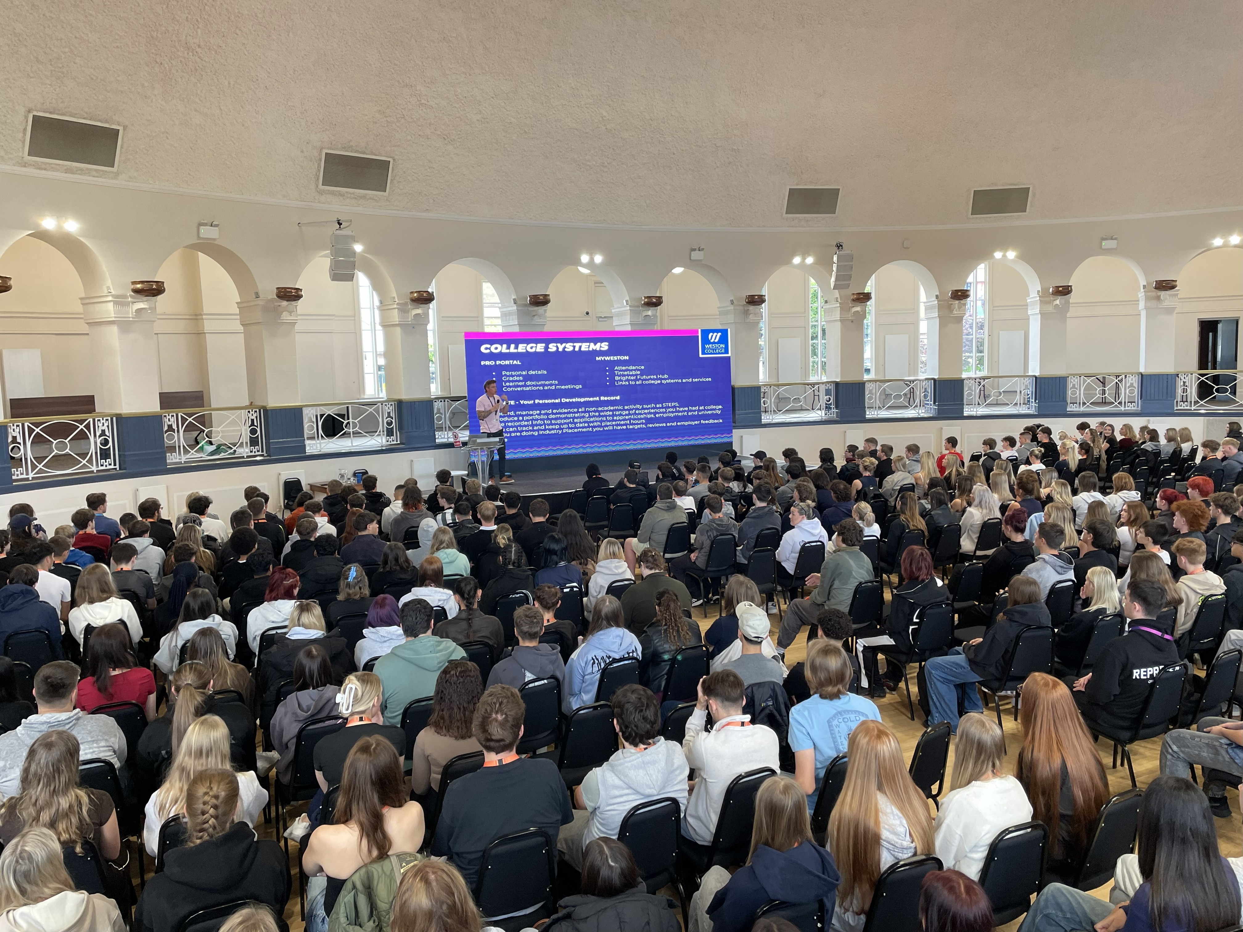Ben Knocks delivering a welcome talk in the Winter Gardens to 200 students