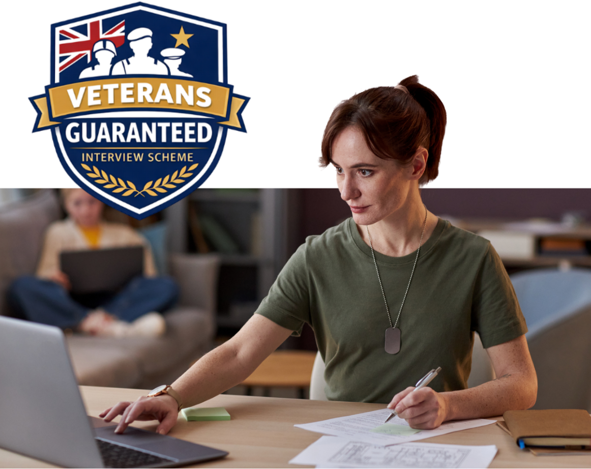 Woman wearing military dog tags working on a laptop, with “Veterans Guaranteed Interview Scheme” badge.