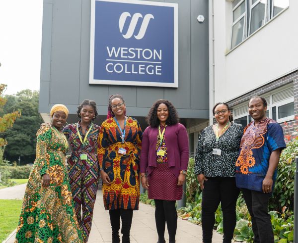 6 people standing in front of Weston College logo