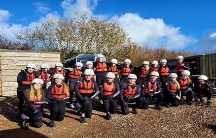 Group of students posing for picture whilst coasteering