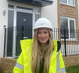 Beth smiling whilst working with St Modwen
