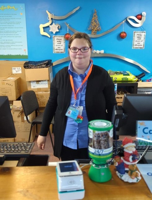 Sam working at Puxton Park stood behind the counter