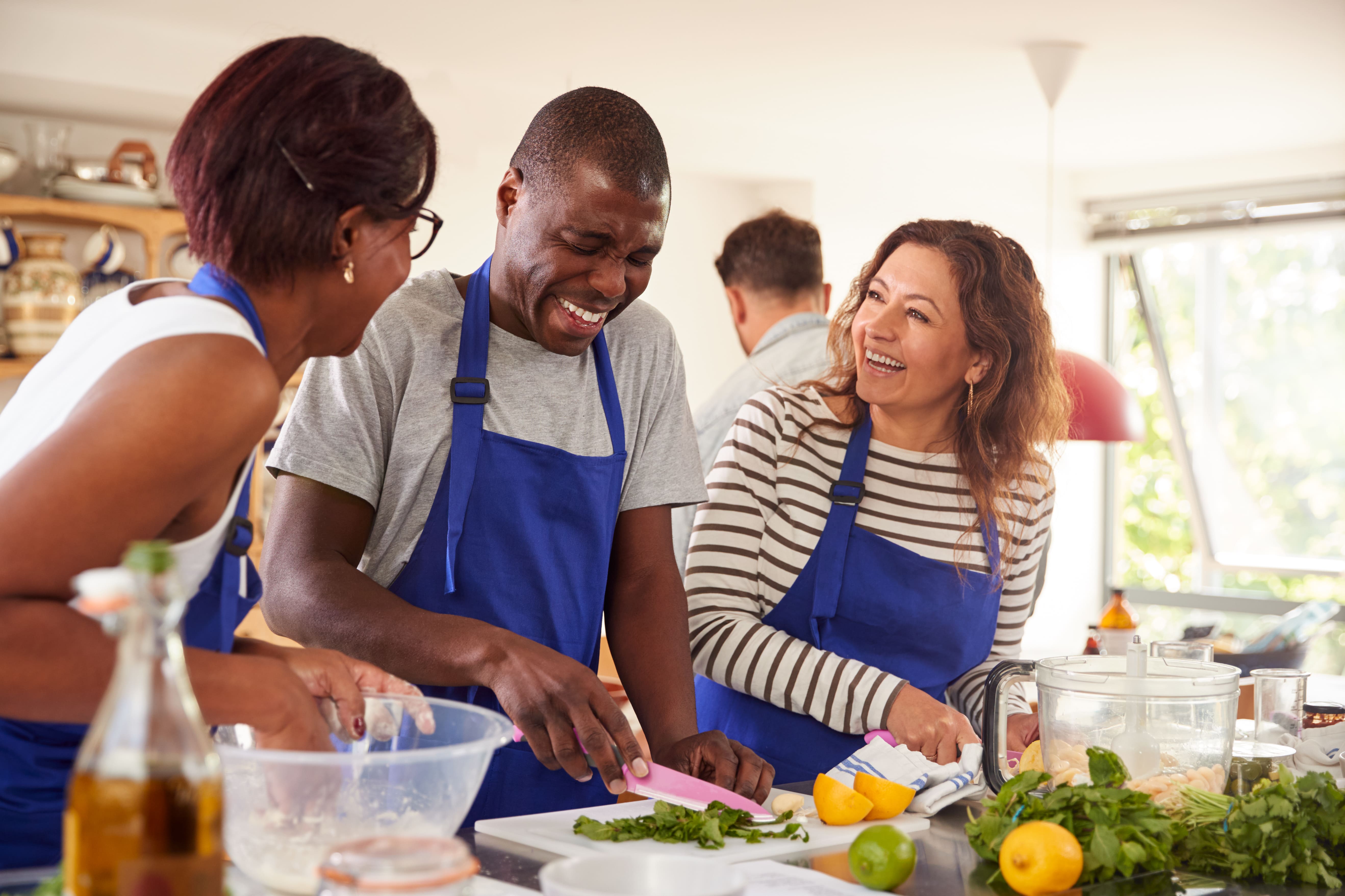 adulst laughing togther while cooking