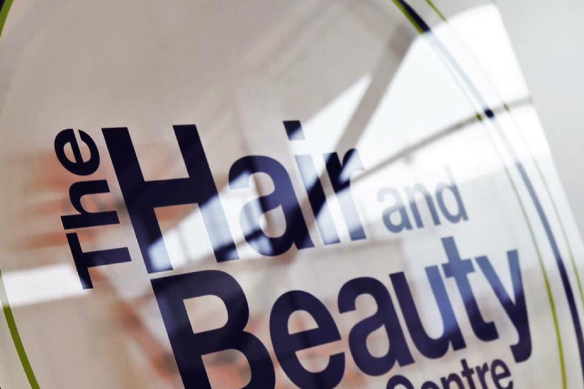 hair and beauty centre signhairdresser talking to women in salon chair 