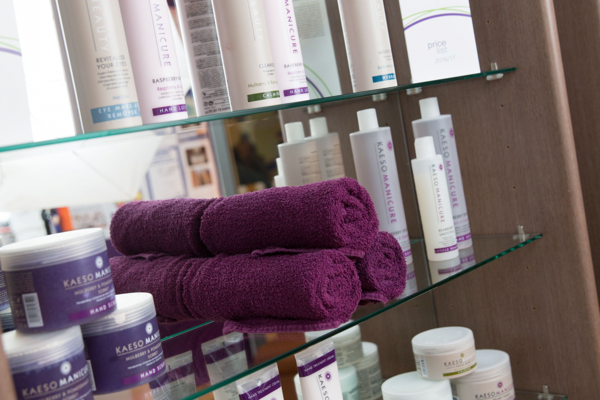 towels and cosmetics on shelves 