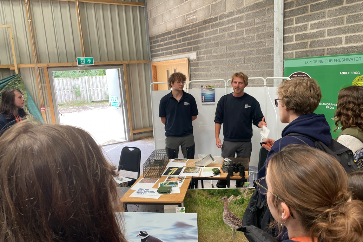 Students standing listening to the talks 