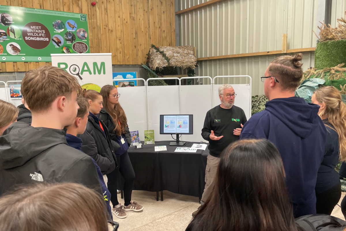 Students standing listening to the talks 